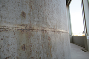 Corroded and pitted 304L stainless steel storage tank.