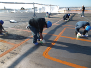 Photo of stripe coat application prior to the full coat of primer on the USS Carl Vinson CVN-70.