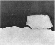 Photomicrograph of cross-section, showing a Cu deposit on the corroded substrate.