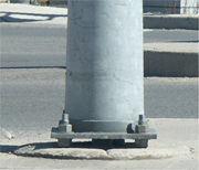 Lamppost galvanized steel base with a gap over the concrete to prevent crevice corrosion and pack rust